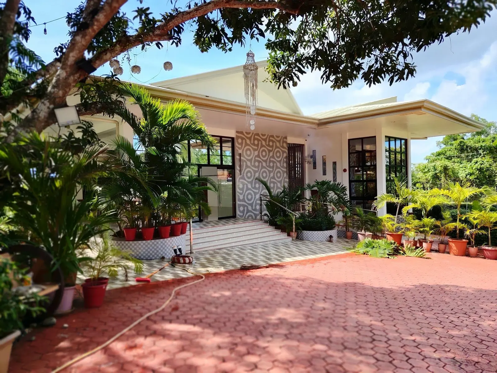 The Rampano Hills venue hall with its patterned feature wall, glass doors and red-brick drive