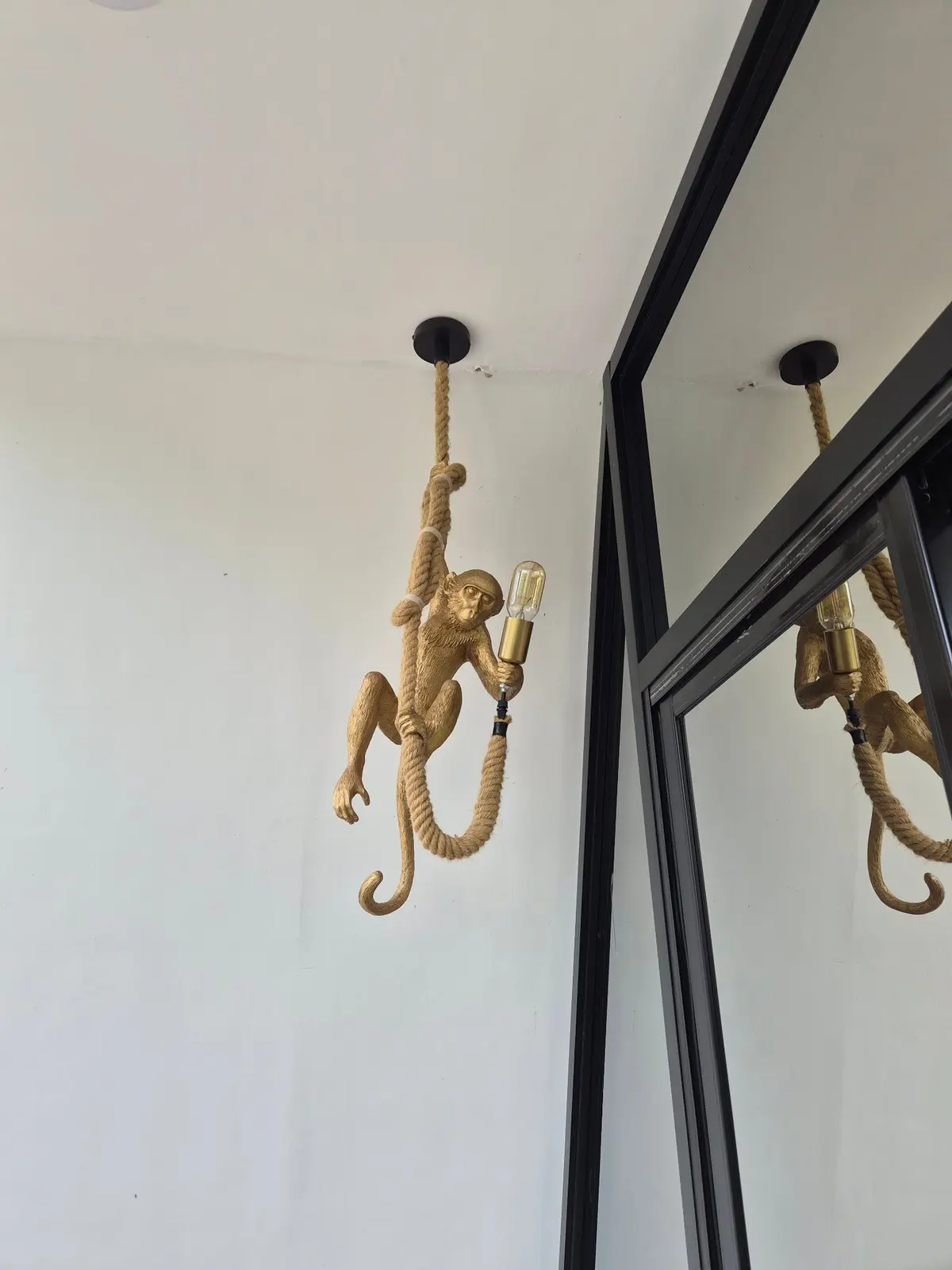 A gold monkey lamp detail by the doors