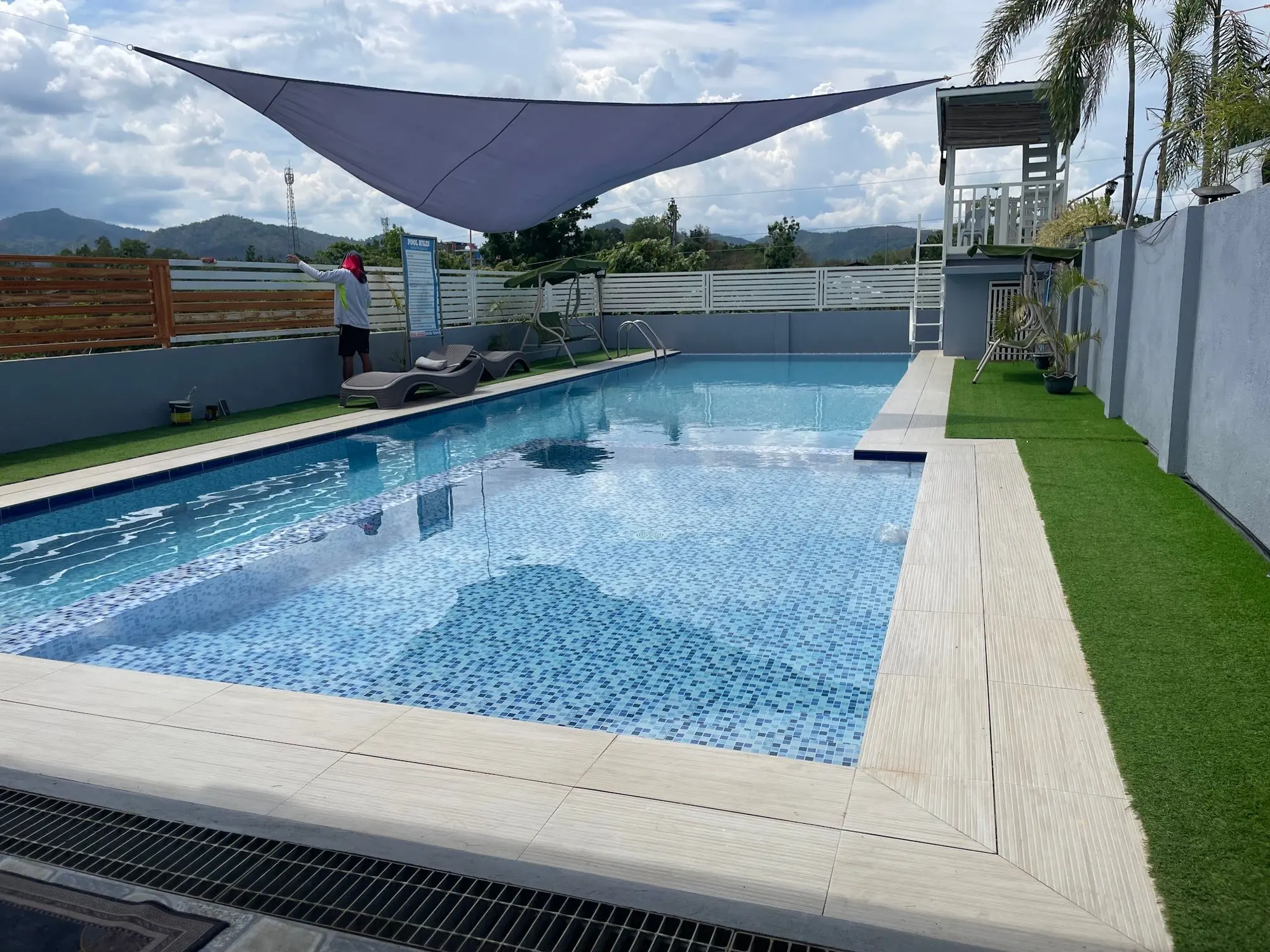 The infinity pool by day under a shade sail
