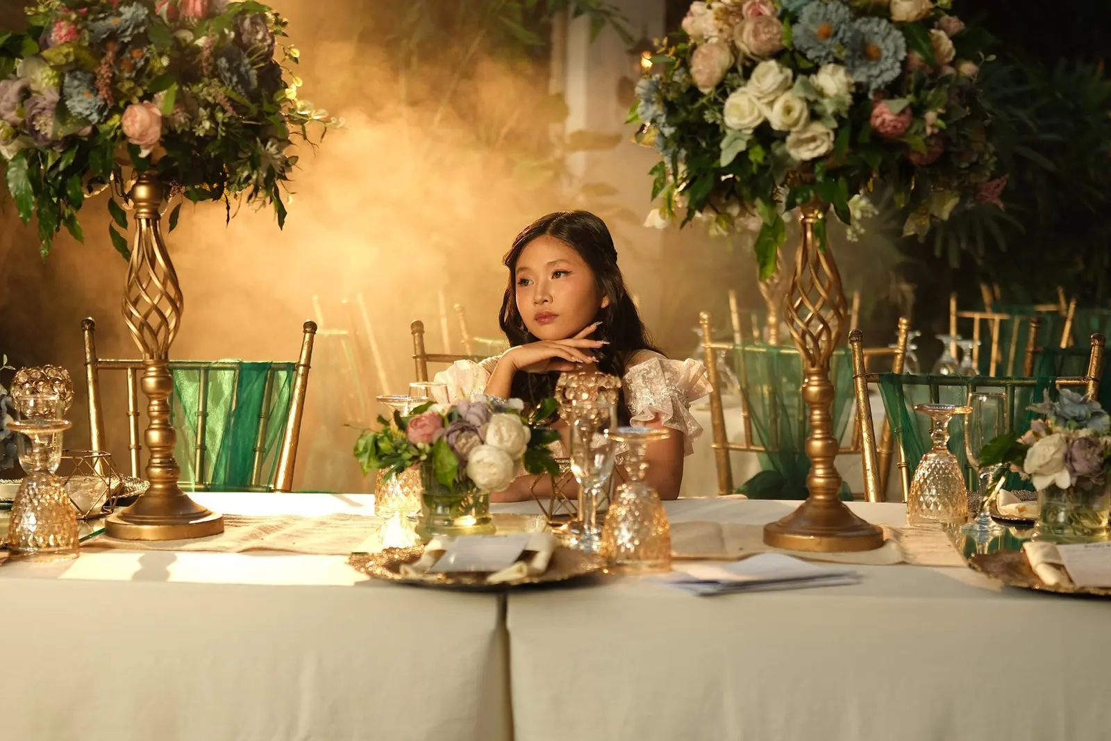Sample styling: a young celebrant at a flower-filled party table